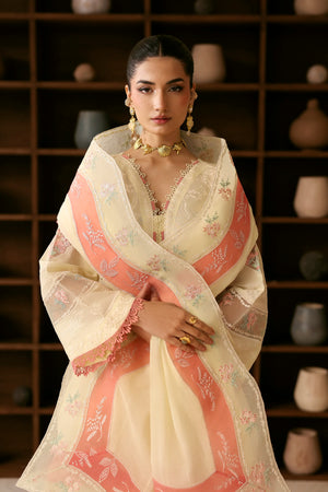 Woman wearing a traditional outfit with a pink and white shawl against a dark background