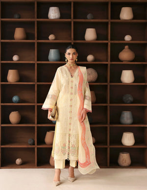 Woman in a traditional outfit standing in front of a wooden shelf with decorative vases.
